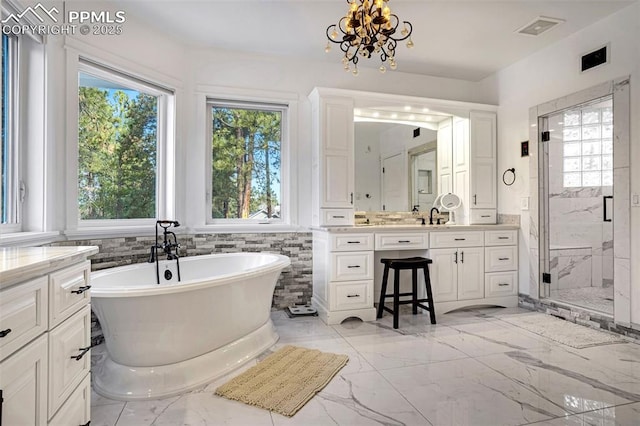 bathroom featuring a healthy amount of sunlight, separate shower and tub, vanity, and tile walls