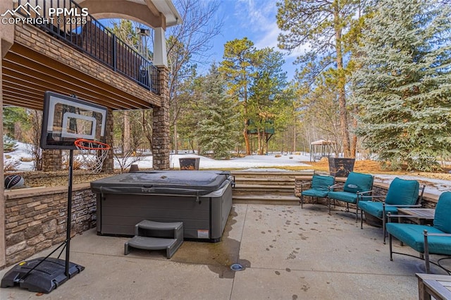 view of patio / terrace with a hot tub