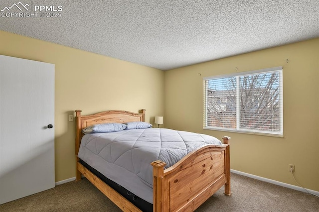 bedroom with a textured ceiling and carpet flooring