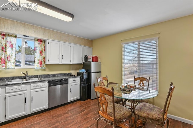 kitchen featuring white cabinetry, appliances with stainless steel finishes, sink, and dark wood-type flooring