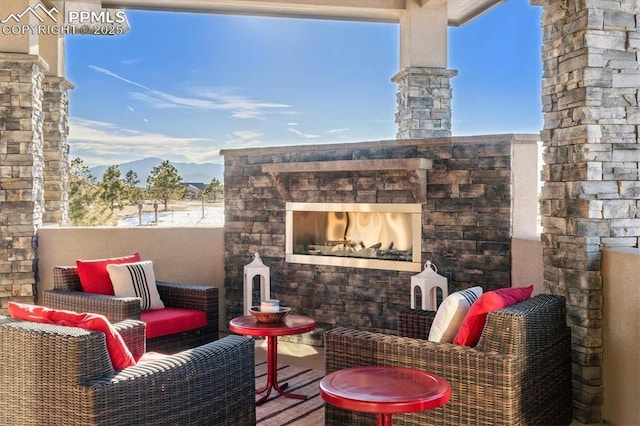 view of patio with an outdoor stone fireplace