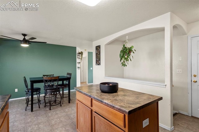 kitchen featuring ceiling fan and a kitchen island