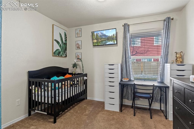 carpeted bedroom featuring a nursery area