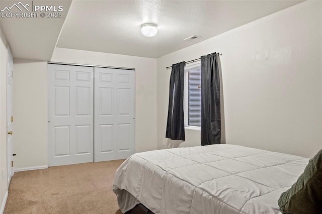 bedroom with light colored carpet and a closet