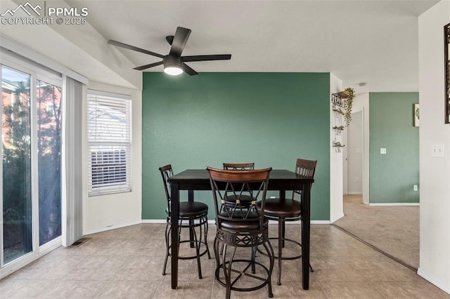 dining space with light carpet and ceiling fan