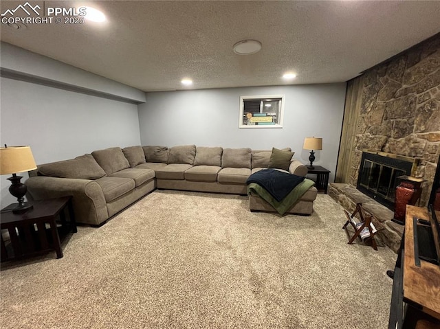 carpeted living room featuring a fireplace and a textured ceiling