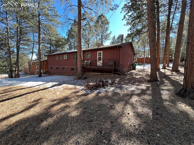 rear view of house with a wooden deck