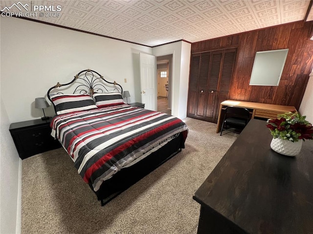 bedroom featuring a closet, ornamental molding, light carpet, and wood walls