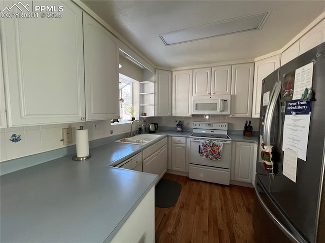 kitchen featuring dark hardwood / wood-style flooring, sink, white cabinets, and white appliances