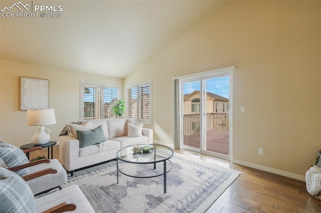 living room featuring hardwood / wood-style floors and high vaulted ceiling