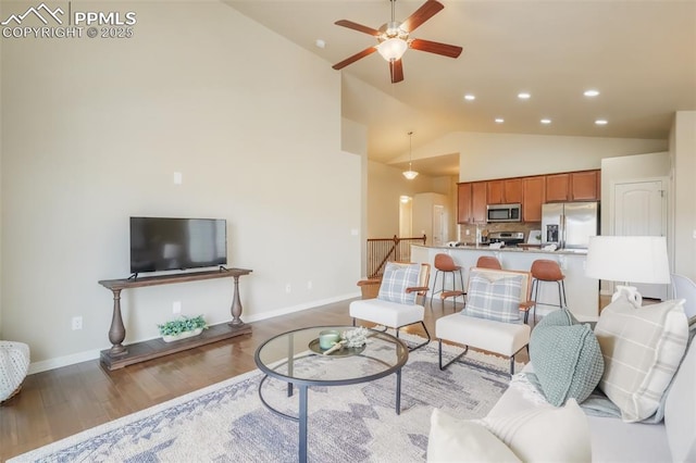 living room featuring high vaulted ceiling, light hardwood / wood-style floors, and ceiling fan