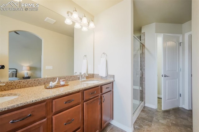 bathroom featuring vanity and a shower with shower door