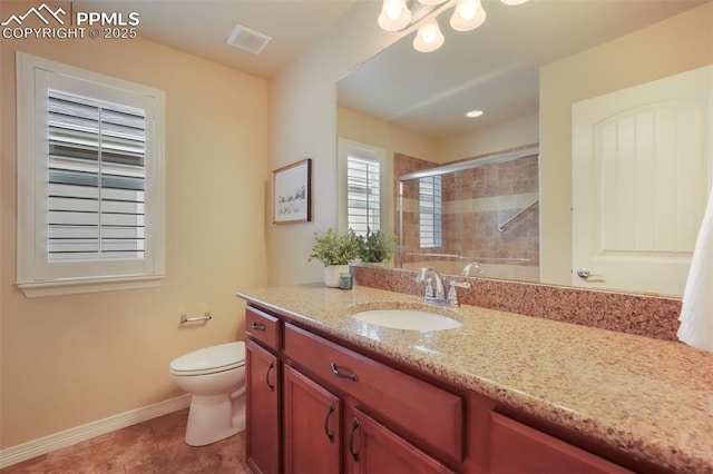 bathroom with vanity, tile patterned floors, toilet, and walk in shower