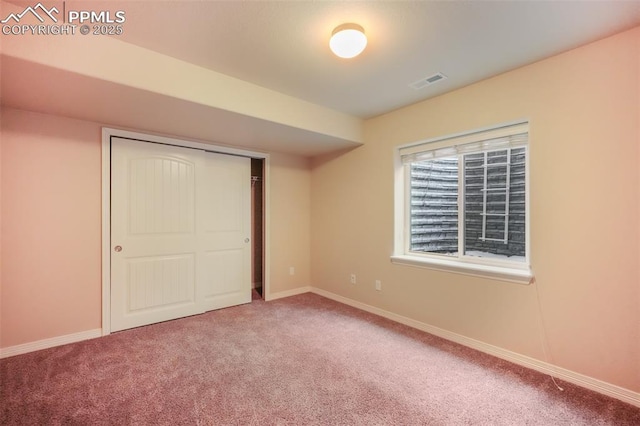 unfurnished bedroom with carpet floors and a closet