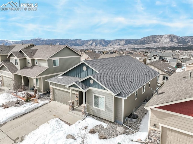 snowy aerial view featuring a mountain view