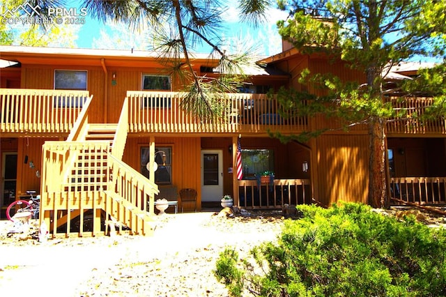 back of house with a deck and stairway