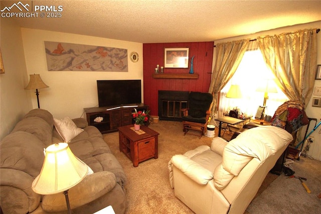 living area featuring light carpet, a fireplace, and a textured ceiling