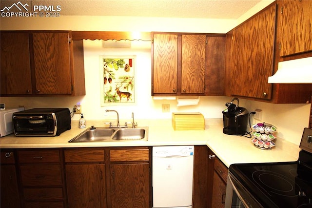 kitchen featuring white dishwasher, sink, and electric stove