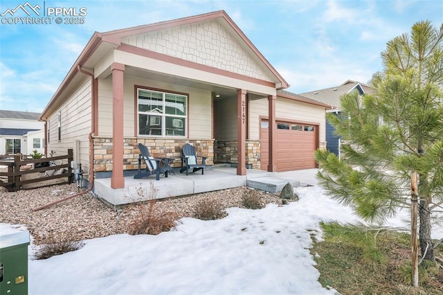 view of front of property with a garage and covered porch