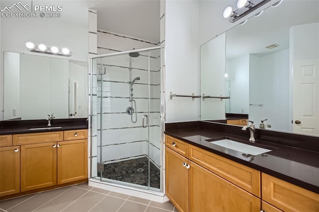 bathroom with vanity, tile patterned floors, and walk in shower