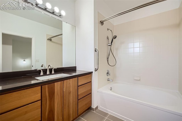 bathroom with tiled shower / bath combo, vanity, and tile patterned floors