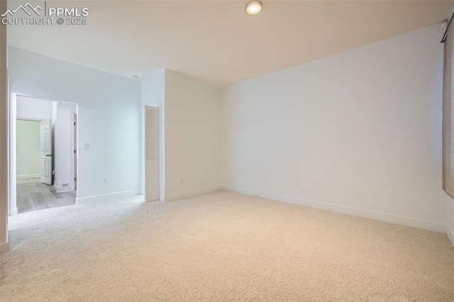 empty room featuring light colored carpet