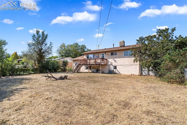 back of house featuring a yard and a deck