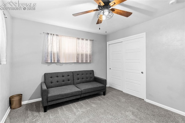 living area with ceiling fan and carpet