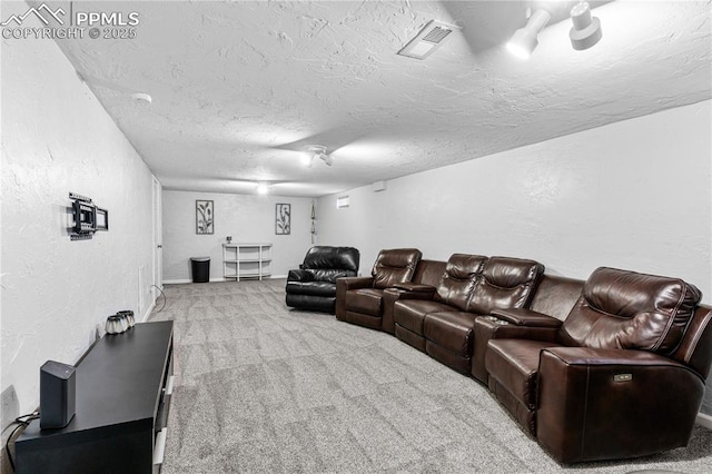 carpeted cinema room featuring a textured ceiling