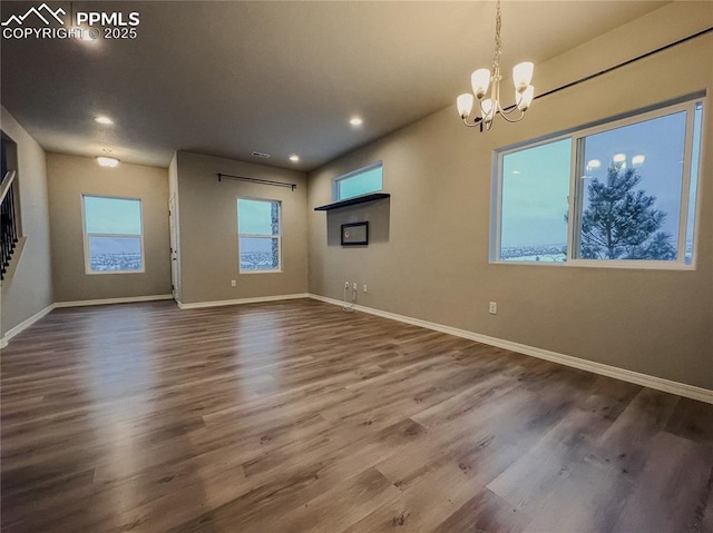 interior space featuring hardwood / wood-style floors and a notable chandelier