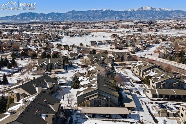 snowy aerial view with a mountain view