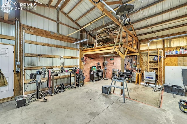 garage featuring a workshop area and metal wall