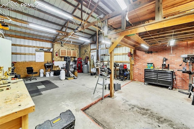 garage with a workshop area and metal wall