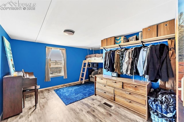 spacious closet with visible vents and wood finished floors