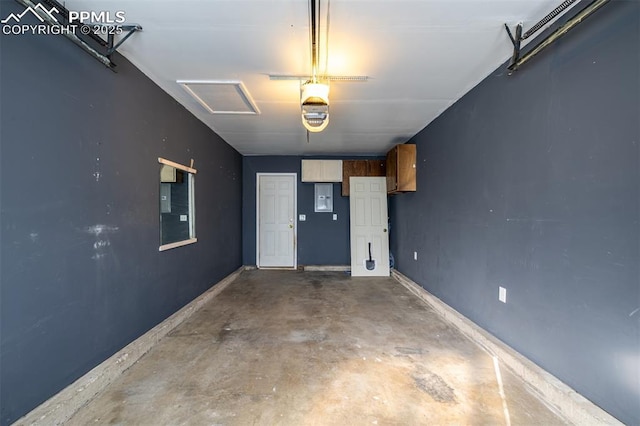 garage with a garage door opener and electric panel