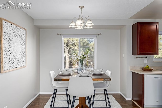 dining room with dark wood-type flooring and a notable chandelier