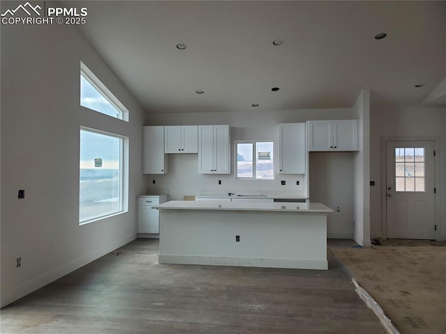 kitchen featuring plenty of natural light, a center island, and white cabinets