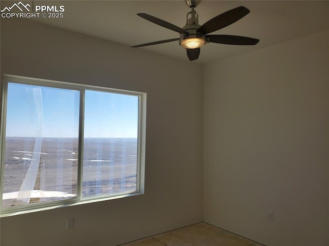 tiled empty room featuring a ceiling fan