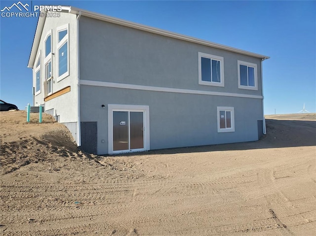 back of house featuring stucco siding