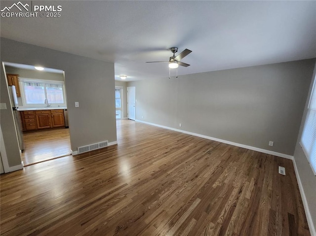 interior space featuring sink, hardwood / wood-style floors, and ceiling fan