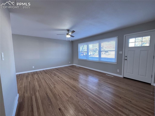 foyer featuring ceiling fan and dark hardwood / wood-style flooring