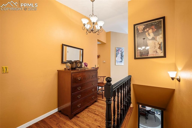 bedroom with a notable chandelier and light wood-type flooring