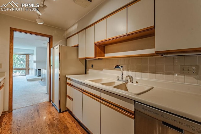 kitchen featuring white cabinetry, appliances with stainless steel finishes, sink, and backsplash