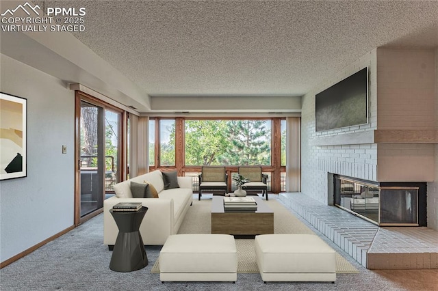 living room with a fireplace, a textured ceiling, carpet, and a wealth of natural light