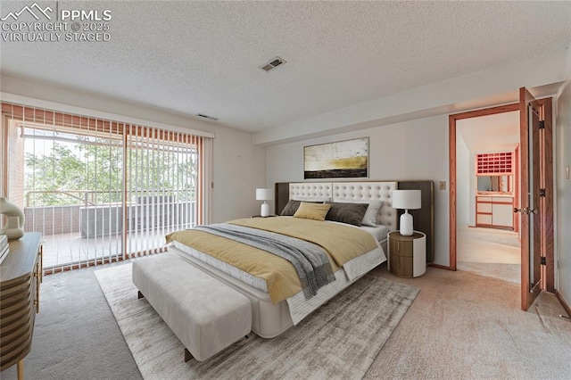 carpeted bedroom with a textured ceiling and access to outside