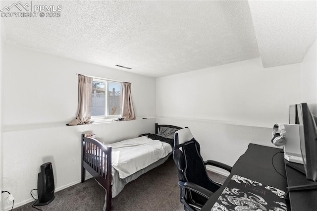 carpeted bedroom featuring a textured ceiling