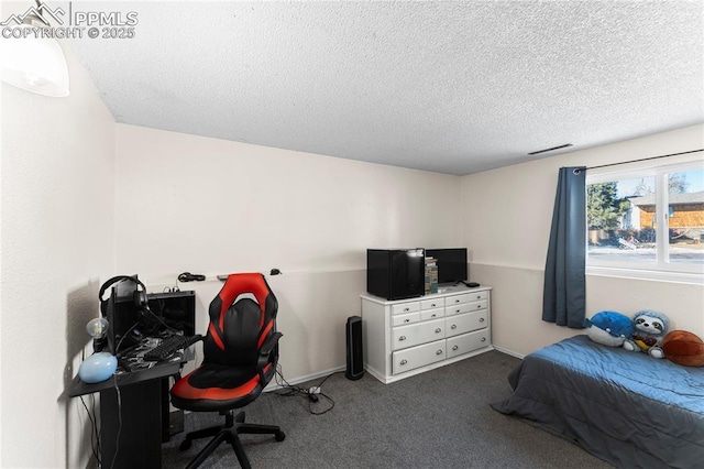 bedroom featuring dark colored carpet and a textured ceiling