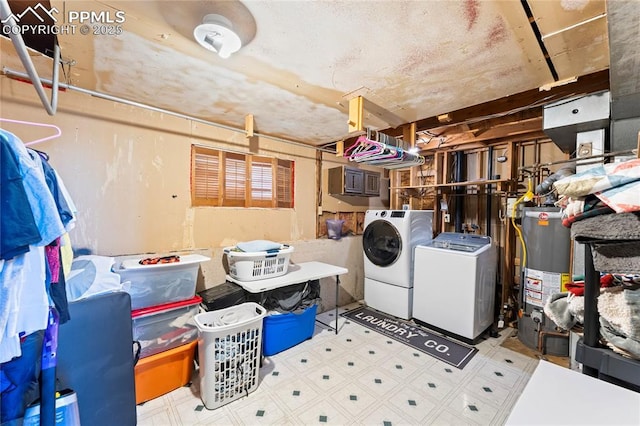 basement featuring water heater and separate washer and dryer