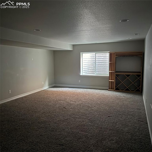 unfurnished room featuring carpet floors and a textured ceiling