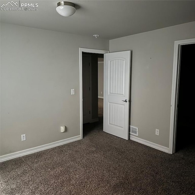 unfurnished bedroom with dark colored carpet